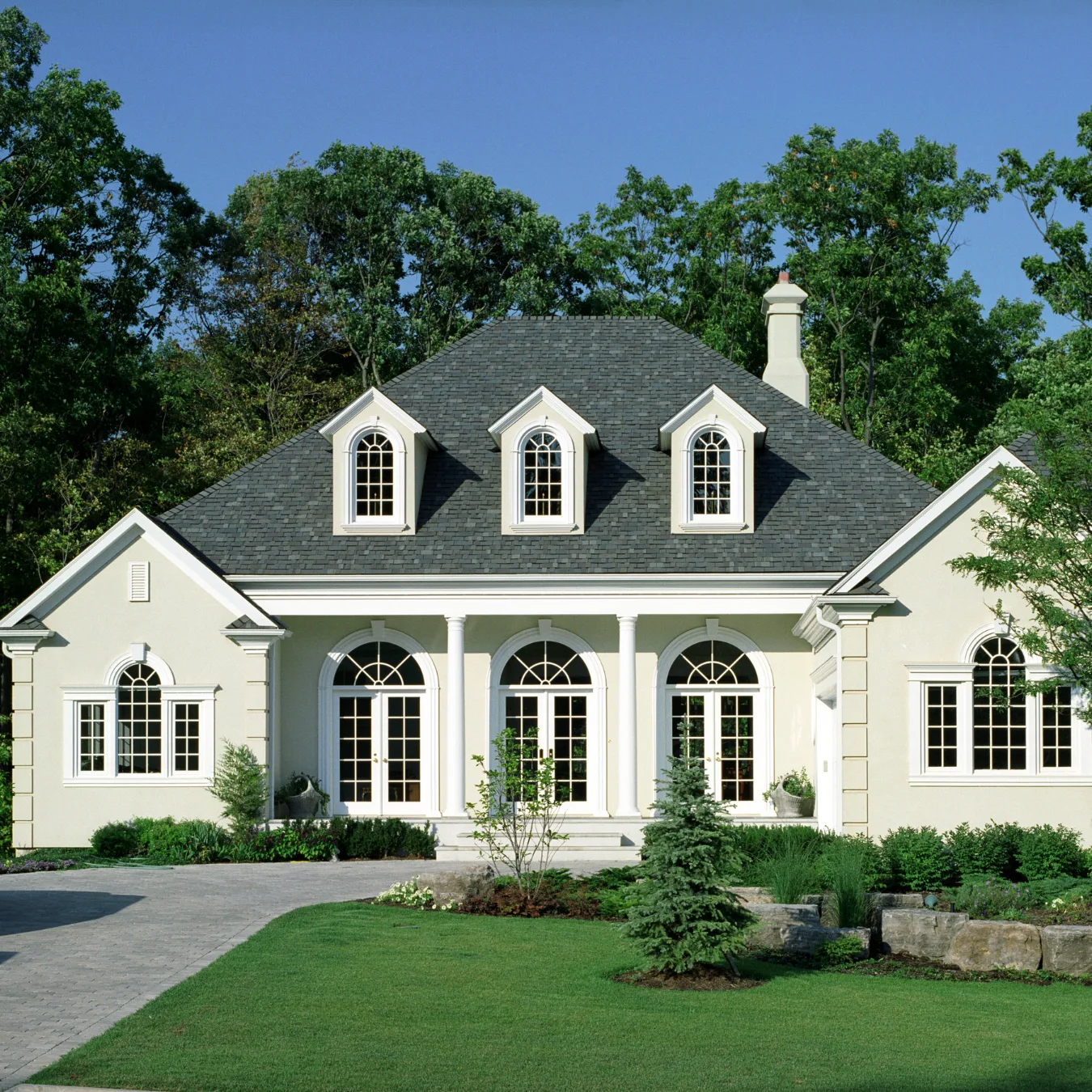 Freshly painted home exterior with landscaped lawn
